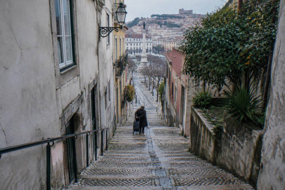 Steep cobblestone lane with worn steps climbing between tall buildings