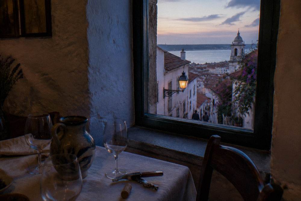 Table set with wine glasses in a small fado venue before a performance