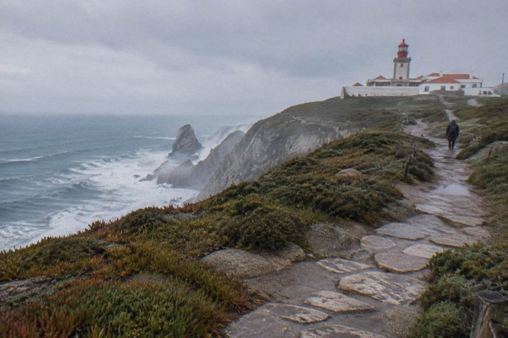 Cliffs at Cabo da Roca above the Atlantic Ocean with a lighthouse on the headland