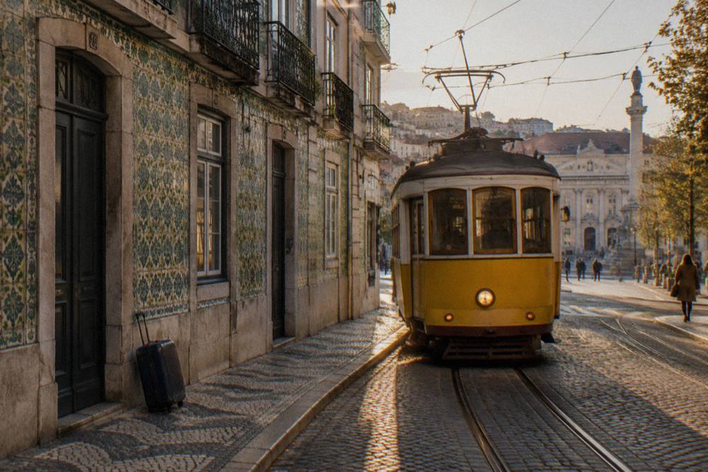 Lisbon street with yellow tram in warm afternoon light