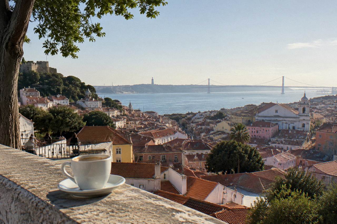 View over Lisbon rooftops toward the Tagus river on a clear day