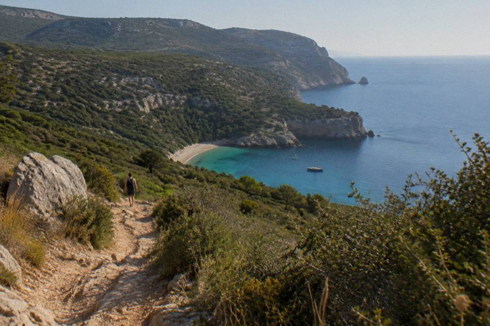 Rocky Arrabida hillsides descending toward a calm blue Atlantic cove