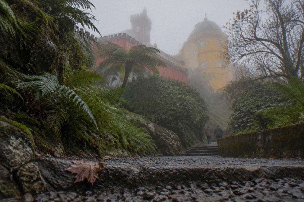 Red and yellow Pena Palace on a green hilltop above Sintra
