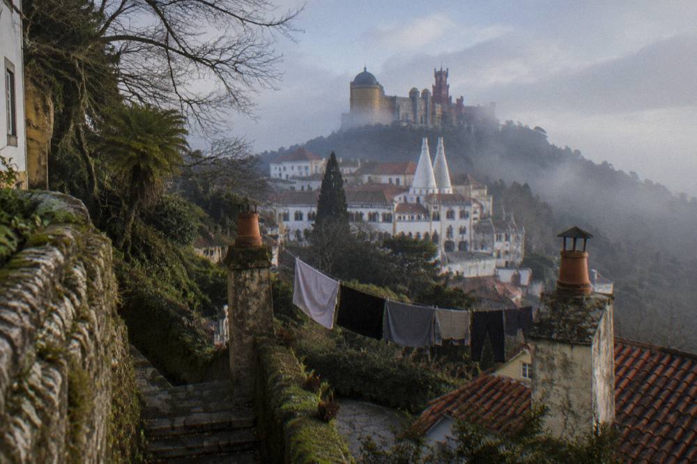 Sintra town seen from a hillside with the National Palace towers in the centre