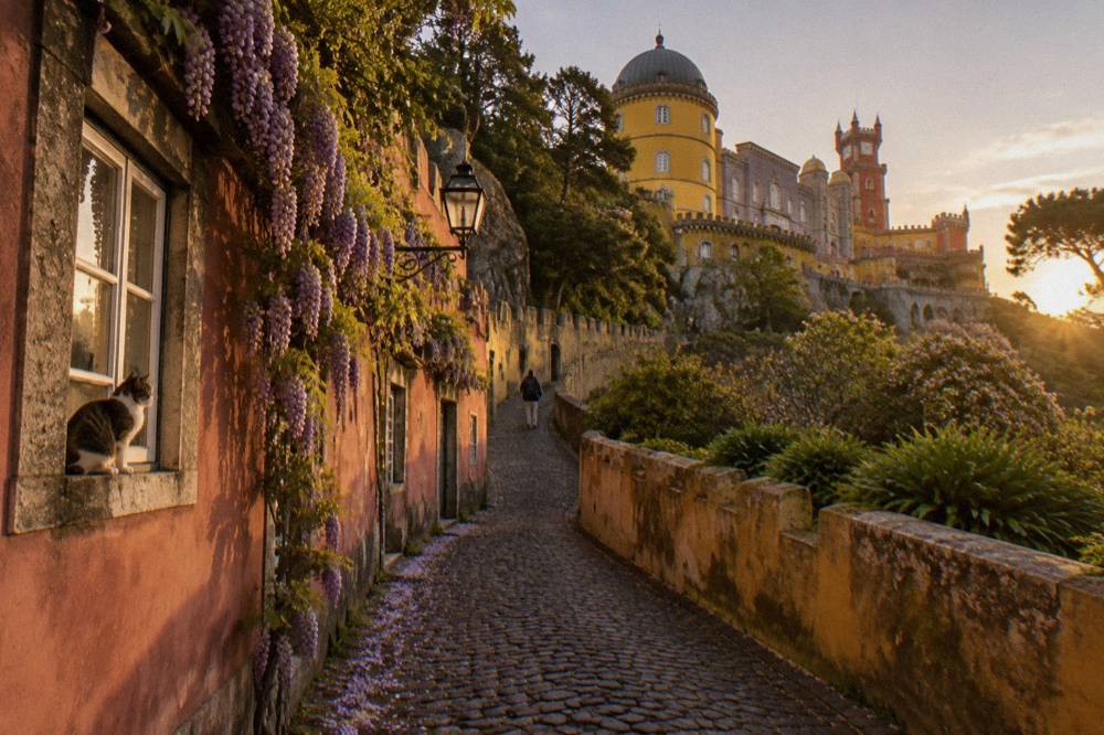 Hillside street in Sintra climbing toward the Pena Palace on the ridge above