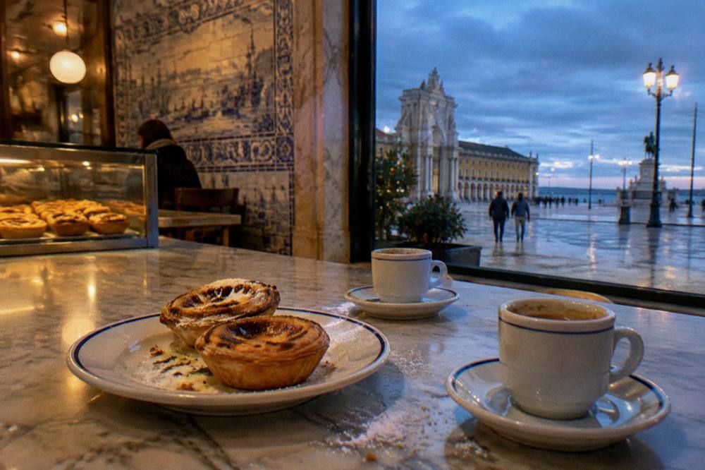 Counter with pastries and coffee cups in a tiled bakery interior